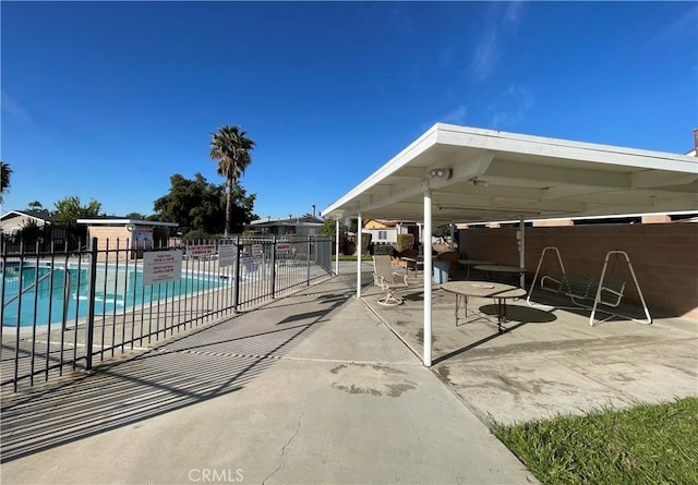 community pool featuring a patio area and fence