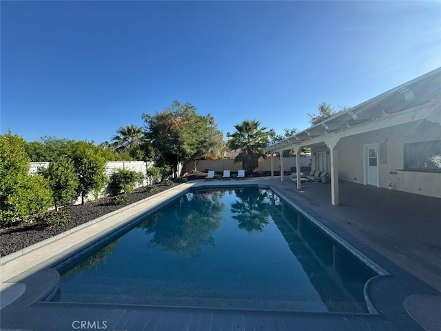 view of swimming pool with a fenced backyard, a fenced in pool, and a patio