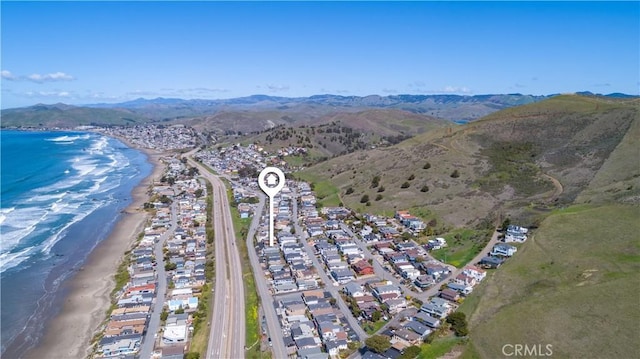 birds eye view of property with a beach view and a water and mountain view