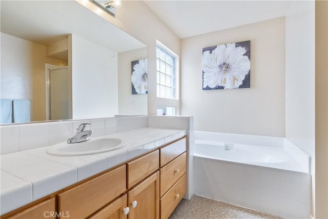 bathroom with vanity, a bath, and a shower stall