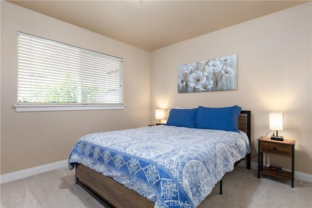 carpeted bedroom featuring baseboards