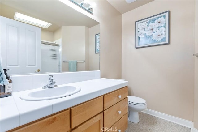 bathroom featuring baseboards, a shower stall, vanity, and toilet