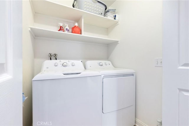 clothes washing area with laundry area and washer and dryer