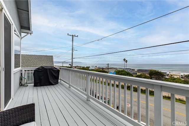 deck featuring a water view and grilling area