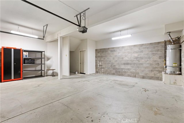 garage featuring secured water heater, a garage door opener, and concrete block wall