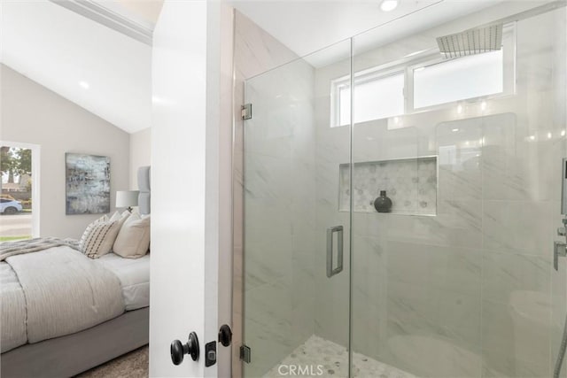 ensuite bathroom featuring a stall shower, vaulted ceiling, and connected bathroom