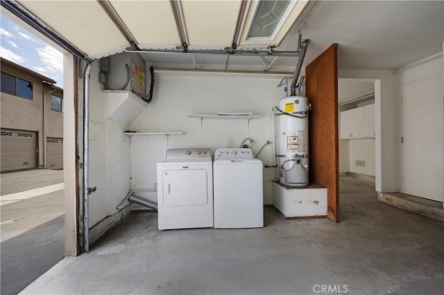 laundry area featuring water heater, laundry area, independent washer and dryer, and a garage