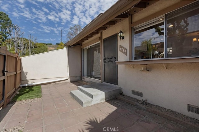 view of patio / terrace featuring fence