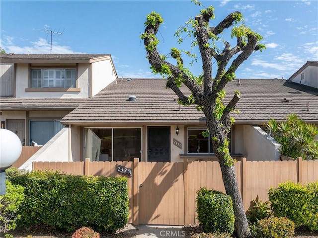 view of front of house featuring a fenced front yard and stucco siding