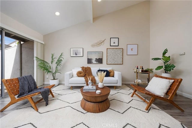 living room with vaulted ceiling, recessed lighting, wood finished floors, and baseboards