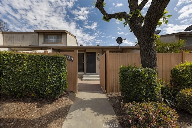 view of front of house with entry steps and fence