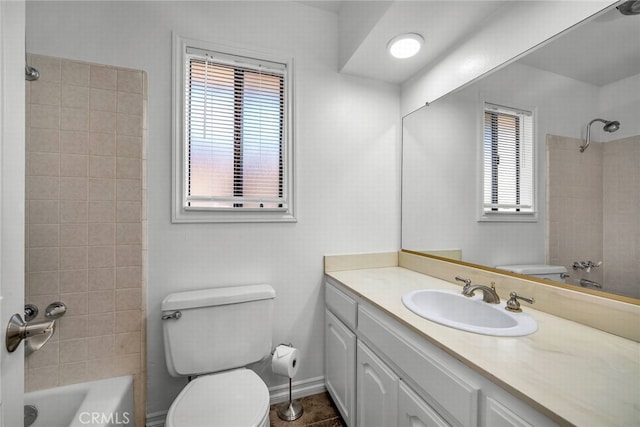 full bathroom featuring toilet, plenty of natural light,  shower combination, and vanity