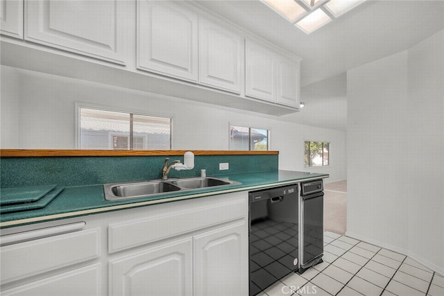 kitchen with dishwasher, light tile patterned flooring, a sink, and white cabinetry