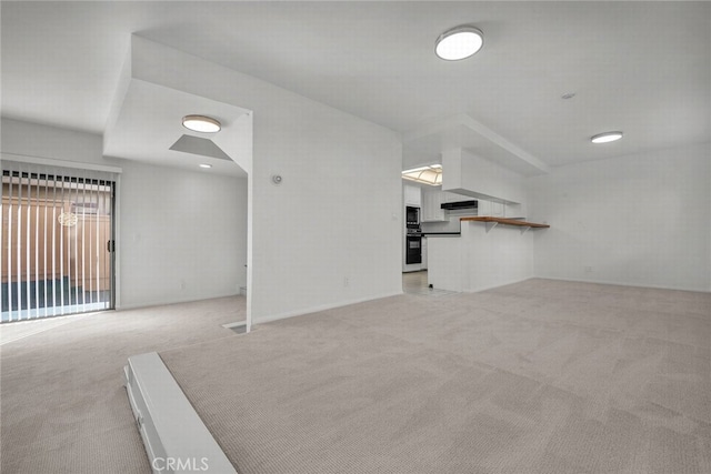 unfurnished living room featuring light colored carpet