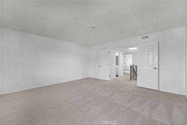 empty room featuring visible vents and carpet flooring