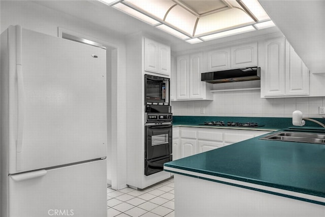 kitchen featuring oven, a sink, gas stovetop, freestanding refrigerator, and built in microwave