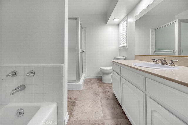 bathroom with toilet, a bathing tub, vanity, and a shower stall