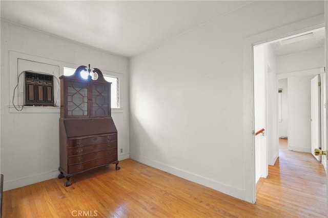 bedroom with light wood-style floors and baseboards