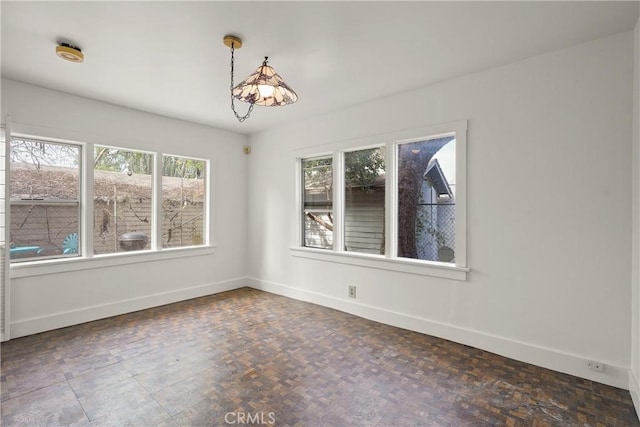 spare room featuring baseboards