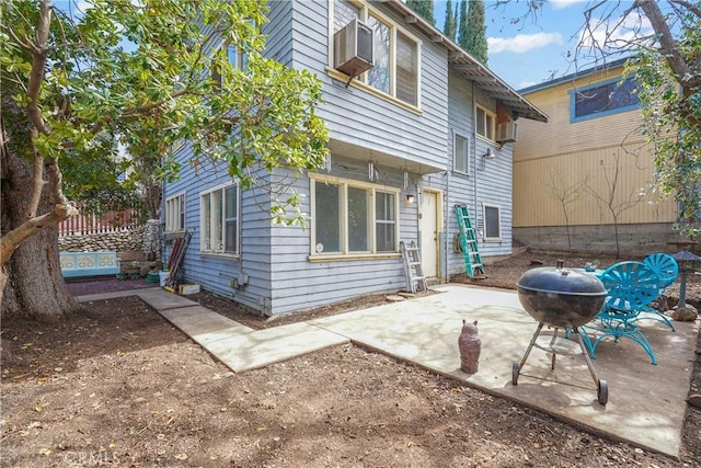 rear view of house featuring a patio and fence