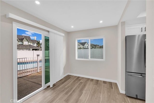 interior space with recessed lighting, light wood-style flooring, and baseboards