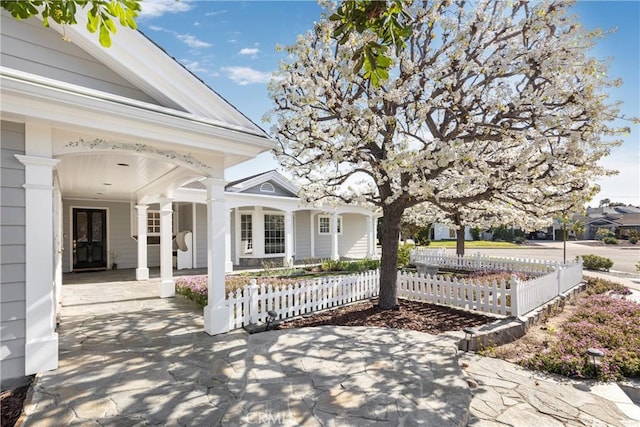 view of patio / terrace with covered porch and a fenced front yard