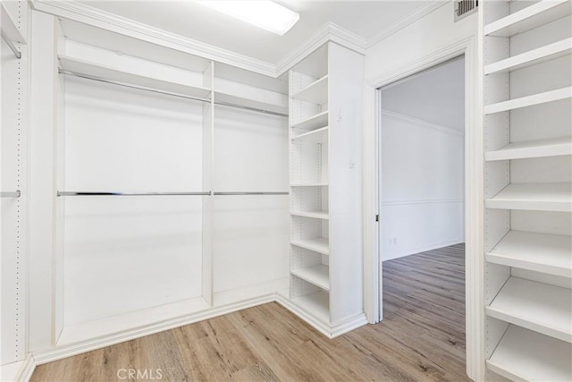 spacious closet with visible vents and wood finished floors