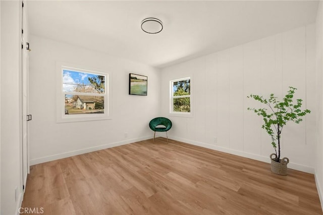 unfurnished room featuring light wood-type flooring and baseboards