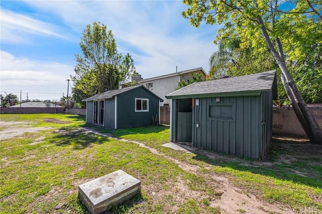 exterior space with an outbuilding and a fenced backyard