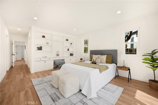 bedroom featuring multiple windows, recessed lighting, and light wood-style floors