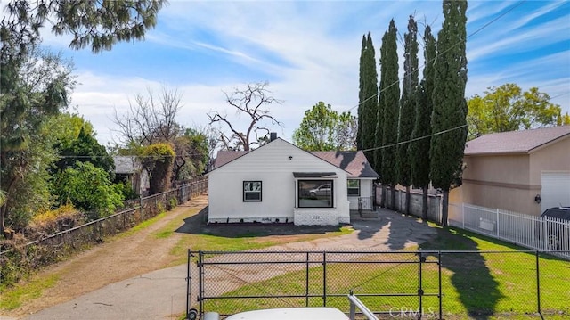 back of property with fence private yard, a lawn, and stucco siding