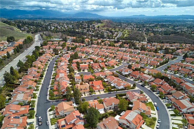 birds eye view of property with a mountain view and a residential view