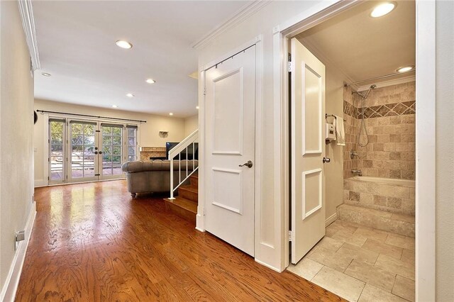 corridor with stairway, crown molding, french doors, light wood-type flooring, and recessed lighting