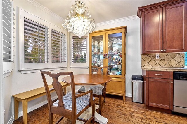 dining area with crown molding, an inviting chandelier, and wood finished floors