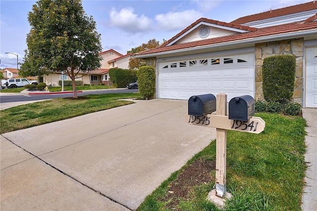 view of front of home with a garage, stone siding, a tile roof, and concrete driveway