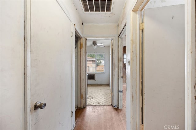 corridor with visible vents and wood finished floors