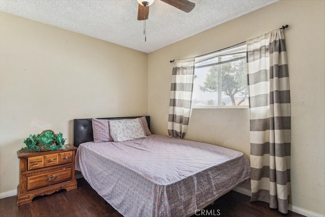 bedroom with ceiling fan, a textured ceiling, baseboards, and wood finished floors