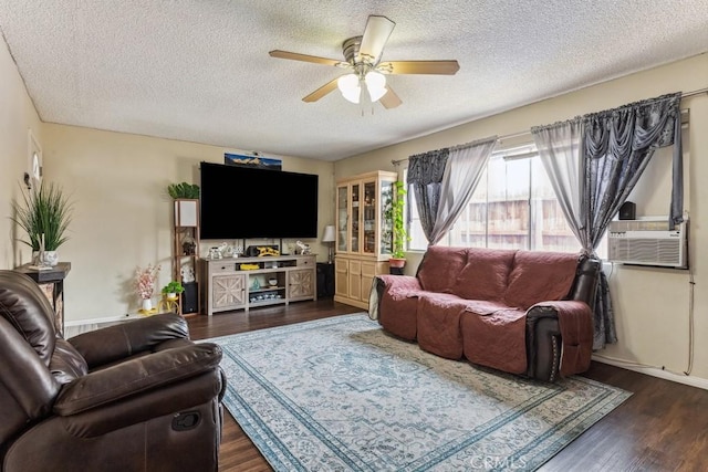 living area featuring wood finished floors, cooling unit, a ceiling fan, and baseboards