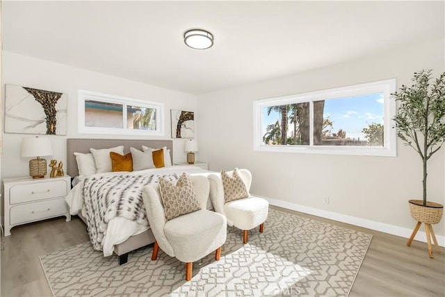 bedroom featuring baseboards and wood finished floors