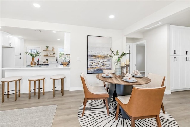 dining area featuring recessed lighting, light wood-style flooring, and baseboards