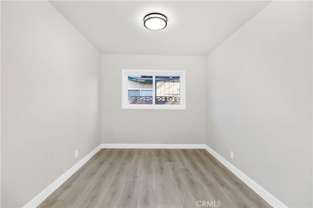 unfurnished room featuring light wood-style floors and baseboards