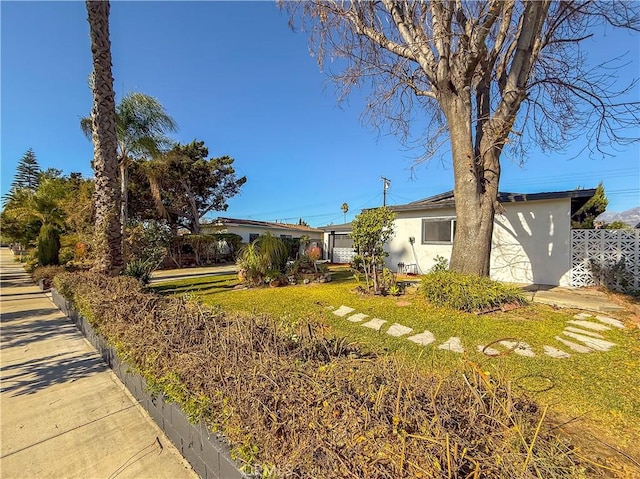 view of front of home with fence and stucco siding