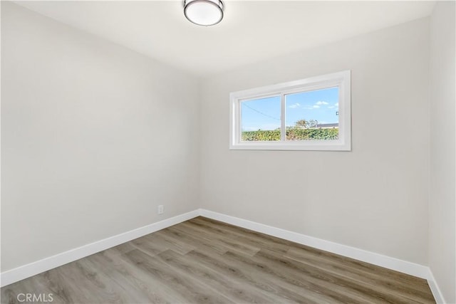 unfurnished room featuring light wood-type flooring and baseboards