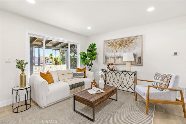 living room with baseboards, wood finished floors, and recessed lighting