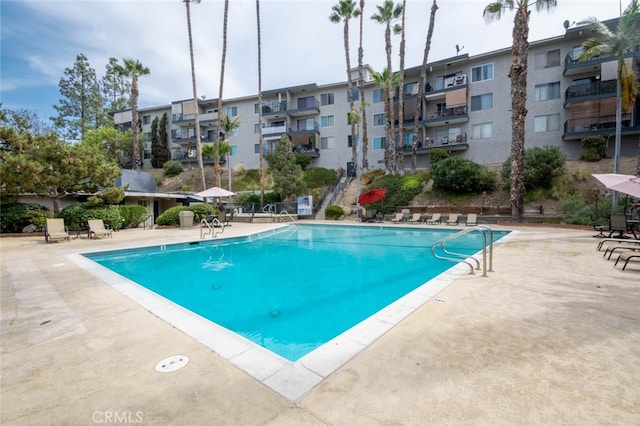 community pool with a patio area