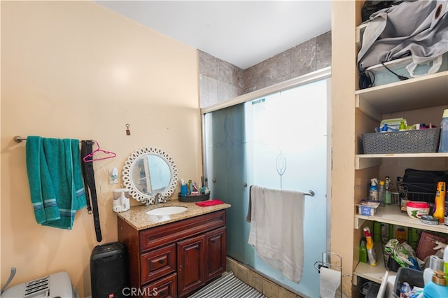 full bath featuring a stall shower and vanity