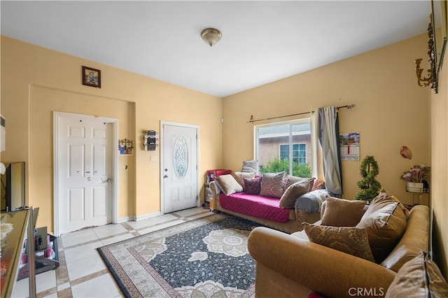 living area featuring light tile patterned floors and baseboards