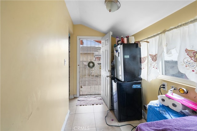 kitchen featuring light tile patterned flooring and lofted ceiling