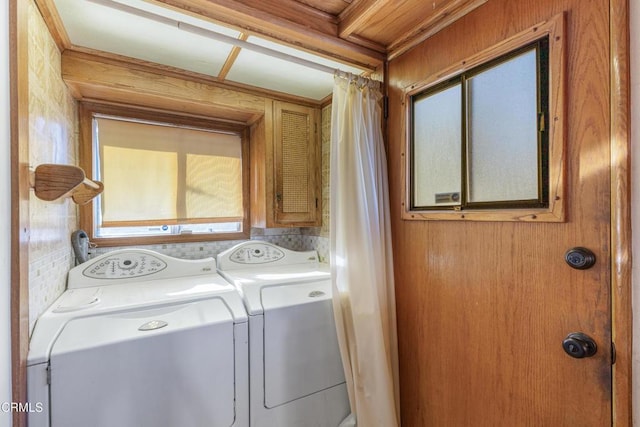 washroom featuring plenty of natural light and washer and dryer