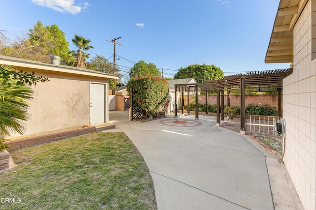 view of yard with an outbuilding, a patio area, a fenced backyard, and a pergola